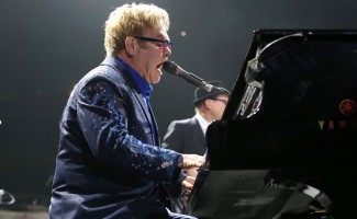 Elton John performing at the piano