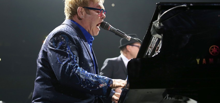 Elton John performing at the piano